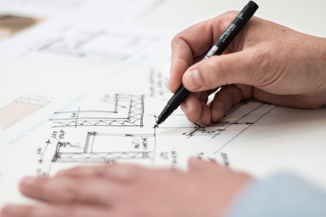 Person drawing an architectural plan for a house extension
