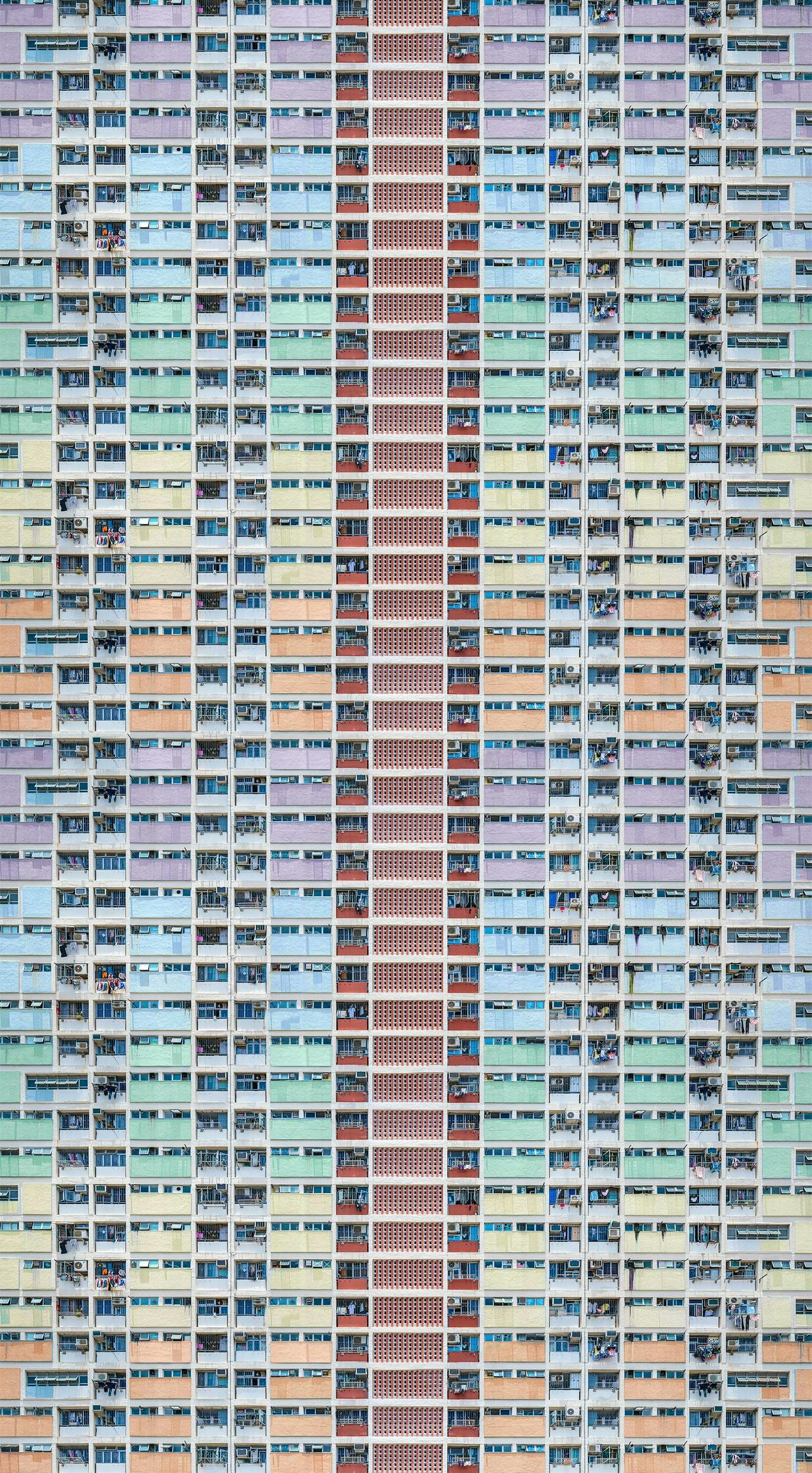 tall apartment block painted in pastel stripes 