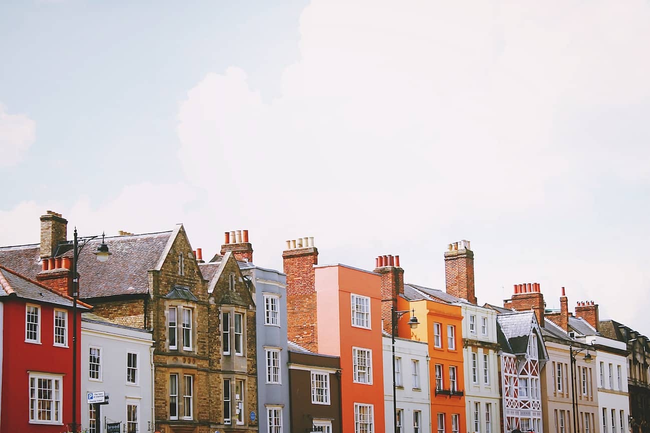 a row of colourful houses of varying sizes on UK street