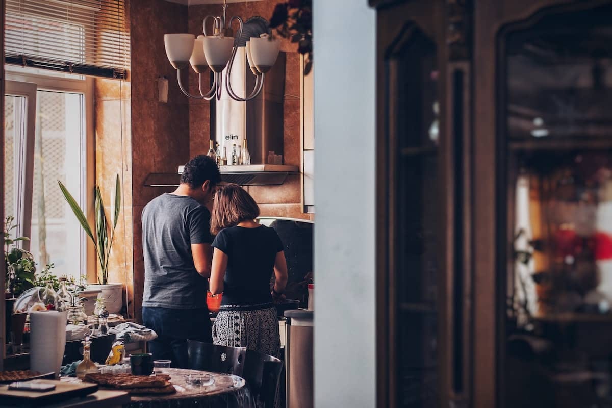 a couple make coffee in their kitchen