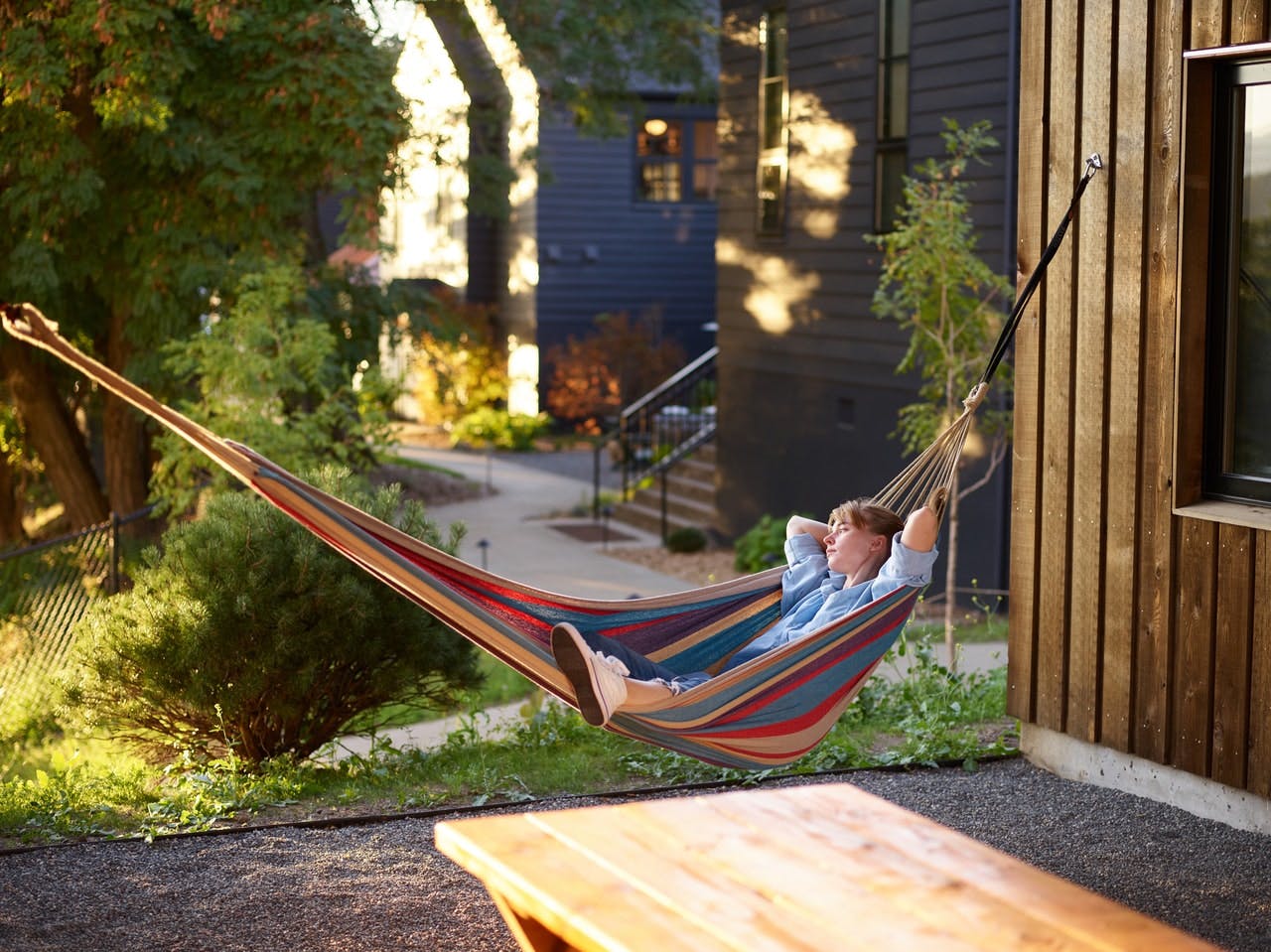 Person resting on a hammock in their garden 