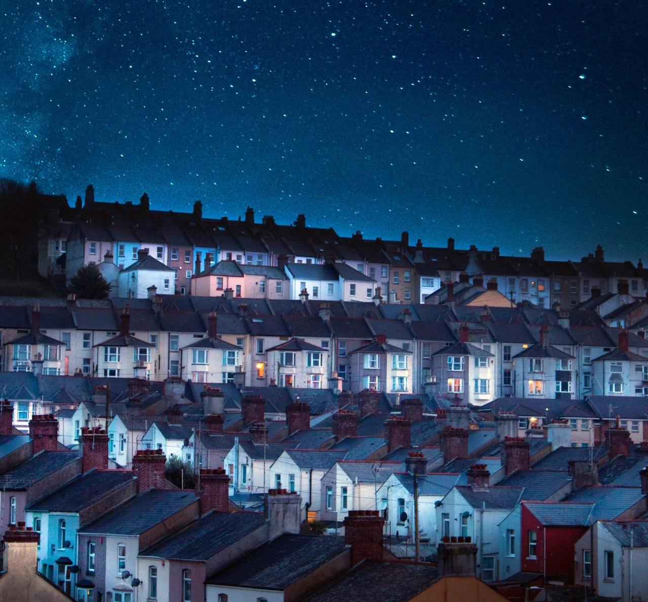 view from night sky over rows of terraced houses