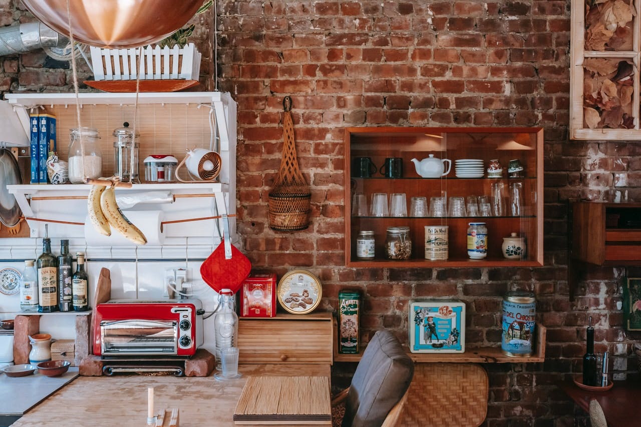 kitchen in rustic home with brick wall and vintage fittings