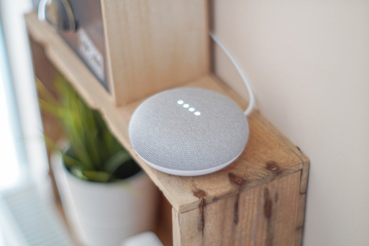 small smart speaker on a wooden shelf 